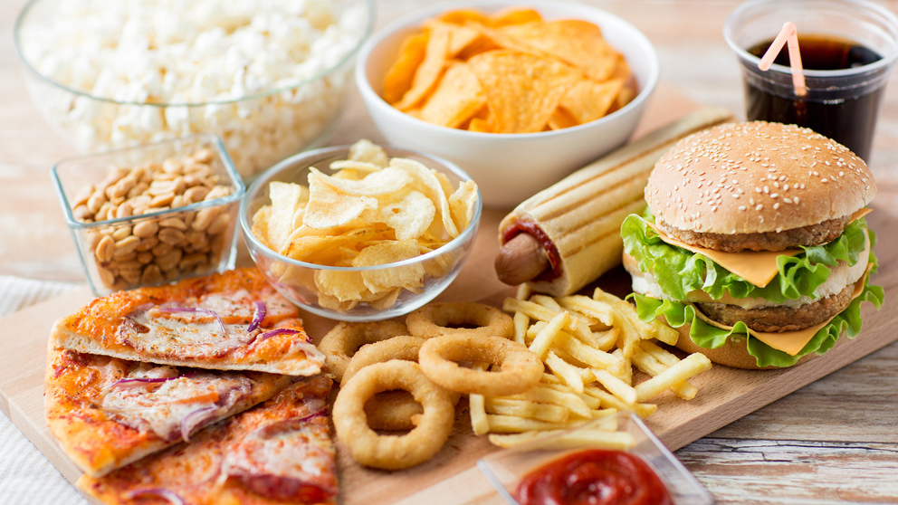 fast food and unhealthy eating concept - close up of fast food s
